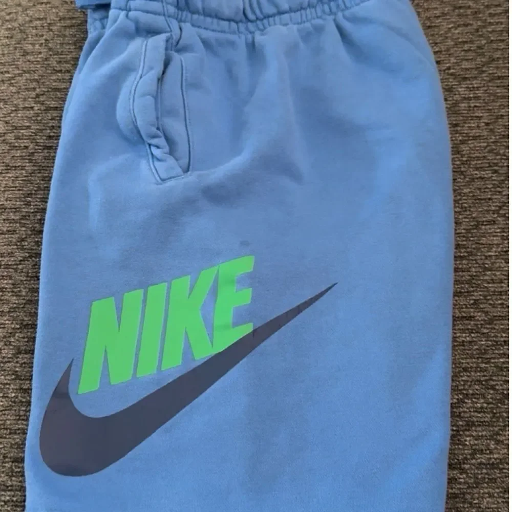 Nike Sportswear Club Fleece shorts royal blue with green Nike and black check